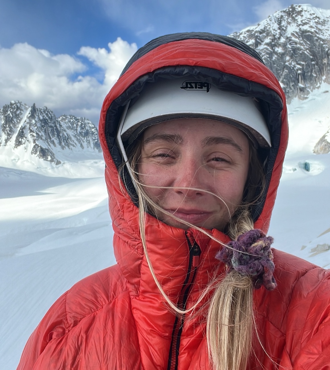 Annie taking a selfie on a crag in the Alaska Range