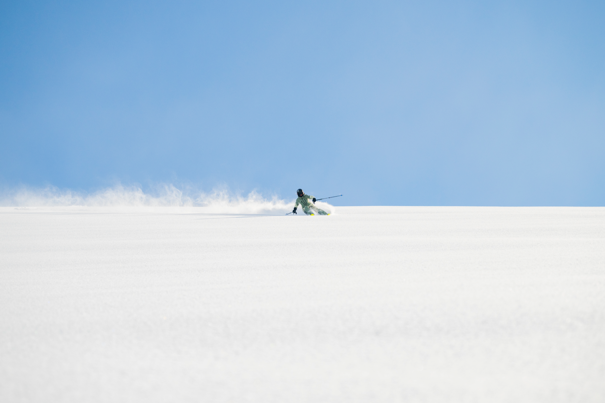Annie skiing across an open snowfield in Valdez, Alaska